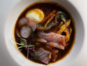 a bowl of soup with meat and vegetables at Locanda Garzelli in Quercianella