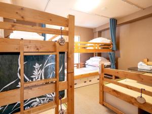 a dorm room with two bunk beds in it at Guest House Nakaima in Fukuoka