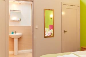 a bathroom with a sink and a mirror at Finest Retreats - The Pig Barn in Ashbourne