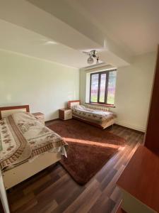 a bedroom with two beds and a window at Emir in Dzhetyoguz