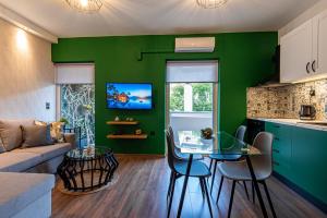a green living room with a table and a couch at Kentia Modern/Artistic City Apartment in Heraklio Town
