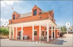 a large orange house with two circles in front of it at HIDALMAR in Arcos de la Frontera
