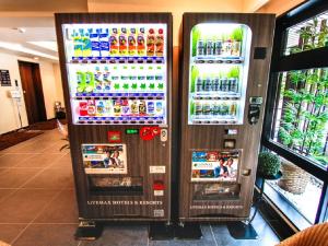 two soda machines in a store with drinks in them at HOTEL LiVEMAX Kyoto Kamogawamae in Kyoto +20 photos