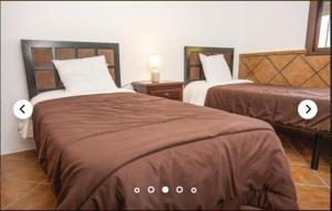 two beds in a hotel room with two at HIDALMAR in Arcos de la Frontera
