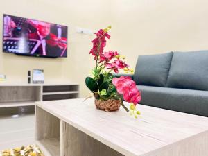 A television and/or entertainment centre at NAZZA Homestay Besut with Swimming Pool