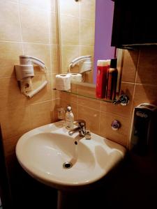 a bathroom with a white sink and a mirror at Caza Latina in Chania Town +24 photos
