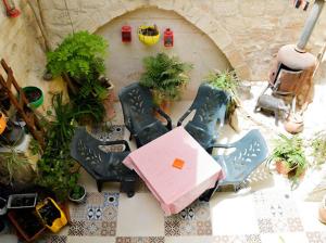 a view of a table and chairs in a garden at Vitrage Guest House in Nazareth