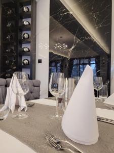 a table with wine glasses and a napkin on it at Хотелски комплекс Белият кон in Targovishte
