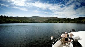 a group of people standing on a boat in the water at BALNEARIO ARNOIA Hotel Balneario in Arnoia +2 photos