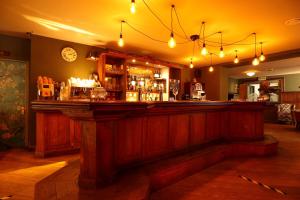 a bar in a pub with a clock on the wall at EuroParcs De Hooge Veluwe in Arnhem +37 photos