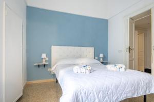 a bedroom with a white bed with two stuffed animals on it at GuestHost - Guest House La Baronessa in Ostuni