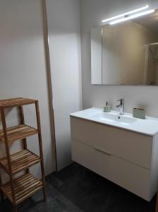 a bathroom with a sink and a mirror at Piso en primera linea de Playa en Laxe in Laxe