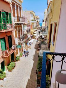 an overhead view of an alley with people sitting on tables at Caza Latina in Chania Town