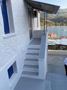a staircase leading up to a white building with a view at Veranta Vosporos in Poros