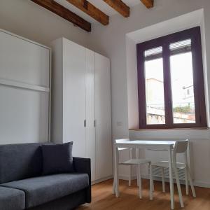 a living room with a couch and a table and a window at Flat in Milano, Porta Romana in Milan
