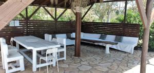 
a patio area with a table, chairs and umbrellas at Zest @ xi beach in Xi
