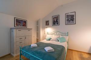 a bedroom with a bed with two pillows on it at Apartments24 Spordi in Rakvere