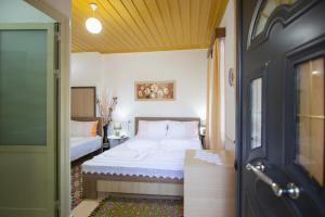 a bedroom with a bed and a door open at The Mosaic House - Shtepia me Mozaik in Përmet
