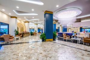 a lobby of a hotel with couches and chairs at Blue Star Hotel in Alanya