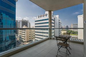 a balcony with a chair and a view of a city at HiGuests - Large Apt in the Heart of Deira Near Clocktower in Dubai