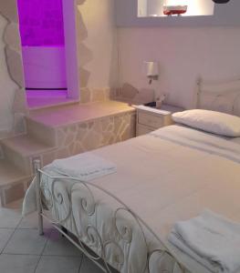 a bedroom with two beds and a purple light at Belvedere in Castro di Lecce