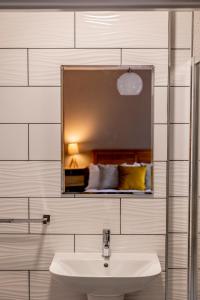 a bathroom with a sink and a mirror at Westertonhill Holiday Lodges - Hot Tub Hire Available in Balloch