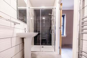 a bathroom with a sink and a shower at Westertonhill Holiday Lodges - Hot Tub Hire Available in Balloch +57 photos