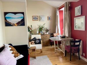 a living room with a table and a dining room at Arnside sea view in Arnside