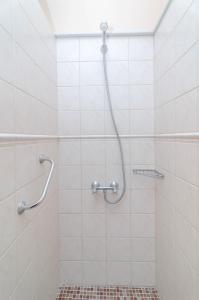 a shower with a hose in a bathroom at Can Pons in Can Picafort +18 photos