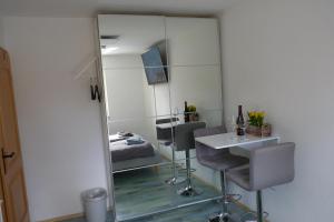 a mirror in a room with a bed and a table at Panoramahaus Hopfner Nähe Zugspitze und Eibsee in Garmisch-Partenkirchen