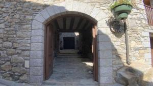 an entrance to a stone building with a wooden door at C13 - Apartamento Casa Llorgodo 4 - Villmor in Cerler