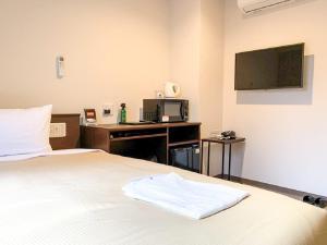 Voodi või voodid majutusasutuse HOTEL LiVEMAX Kyoto Nijojonishi toas
