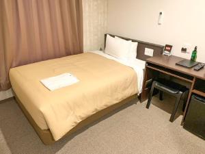 Voodi või voodid majutusasutuse HOTEL LiVEMAX Kyoto Nijojonishi toas