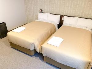 Voodi või voodid majutusasutuse HOTEL LiVEMAX Kyoto Nijojonishi toas