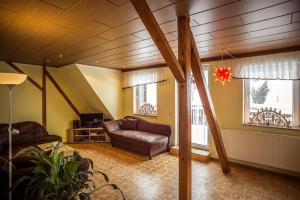 a living room with a couch and a tv at Ferienhof Kürschner in Drebach