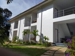 a white building with palm trees in front of it at Sea-Sun Bungalow & Resort in Ko Chang