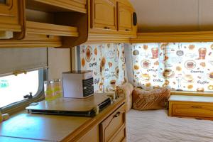 an rv kitchen with a microwave on a counter at Sunny House Caravans in Sozopol +18 photos