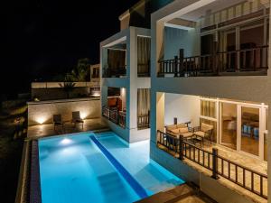 a villa with a swimming pool at night at Zanzibar DT Beachfront Villa in Mkunguni