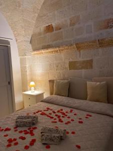 a bedroom with a bed with red roses on it at LATA LUXURY HOME CASA VACANZE in Brindisi