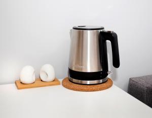 a coffee maker on a counter next to two eggs at Pepleri Studio 20 in Tartu