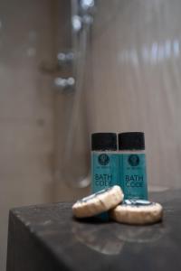 a container of bath soak next to a bun and a bottle of bread at Parthenis Riviera Hotel in Athens