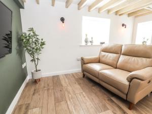 a living room with a couch and a window at Afallon Cottage in Rhyl