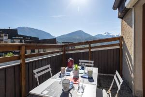 einen Tisch auf dem Balkon mit Bergblick in der Unterkunft Terrasse des Lupins in Embrun