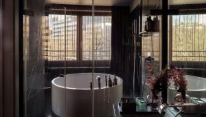
a bathroom with a large mirror and a large tub at Roomers in Frankfurt/Main
