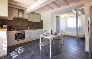 a kitchen with a table and chairs in a room at Lovely Home In Santa Maria Albiano in Santa Maria Albiano