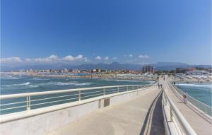 a view of a beach with people walking on a bridge at Lovely Home In Santa Maria Albiano in Santa Maria Albiano