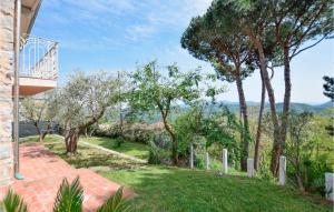 a house with a garden with trees and a pathway at Lovely Home In Santa Maria Albiano in Santa Maria Albiano +16 photos