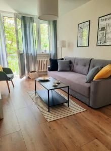 a living room with a couch and a coffee table at Apartament w centrum Wrocławia in Wrocław