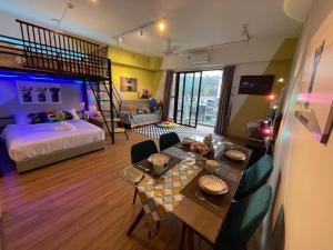 a living room with a bed and a dining table and a bedroom at Kaw Supreme Theme WIFI Luxury 7 PAX Genting Pool & Mountain View Cuti Genting Homestay Midhills in Genting Highlands +34 photos