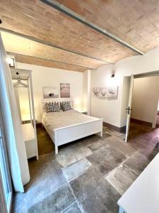 a bedroom with a white bed and a mirror at Guest house Le due lagune in Orbetello